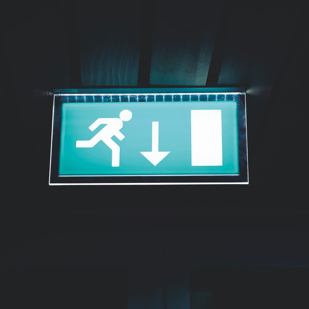 Bright fire exit sign from smoke detectors fitted by Security system installers Currant Live.