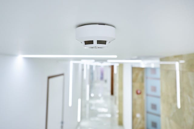 Cost-effective fire alarm installation with a smoke detector mounted on the ceiling for safety and fire protection.