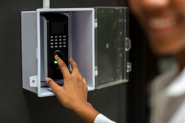 A person using fingerprint scan for access control, emphasising why access control systems are essential for identity verification and security.
