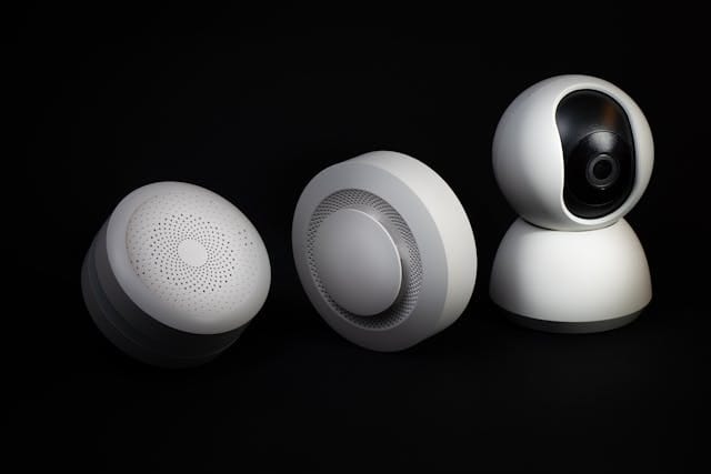 Intruder alarm system features including motion sensors and a security camera with modern, sleek design."