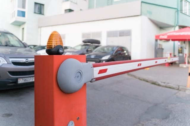 Car park barrier with warning light, demonstrating the benefits of installing electric gates for enhanced vehicle access control.