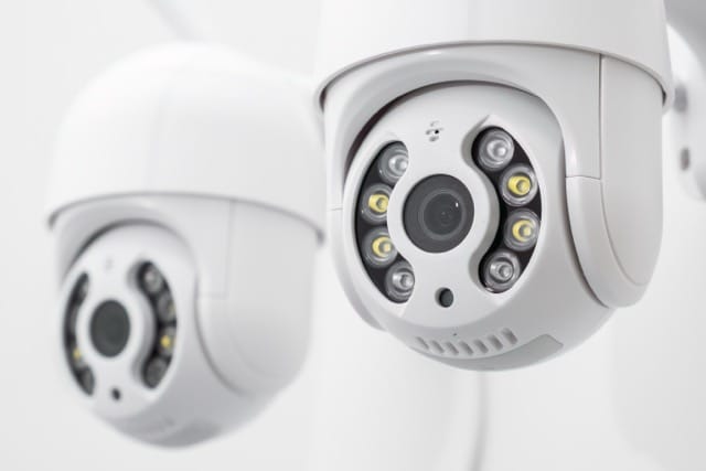 CCTV Camera displaying in cctv shop and people are choosing which one is better for them.
